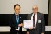 Dr. Nagib Callaos, General Chair, giving Prof. Shigehiro Hashimoto the best paper award certificate of the session "Biomedical Engineering." The title of the awarded paper is "Analysis of Cyclic Deformation of Erythrocyte in Couette Type of Pulsatile Shear Field."
